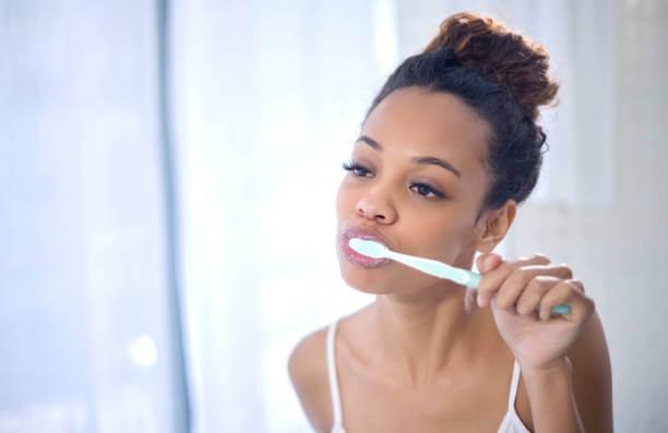 photo of a woman brushing her teeth