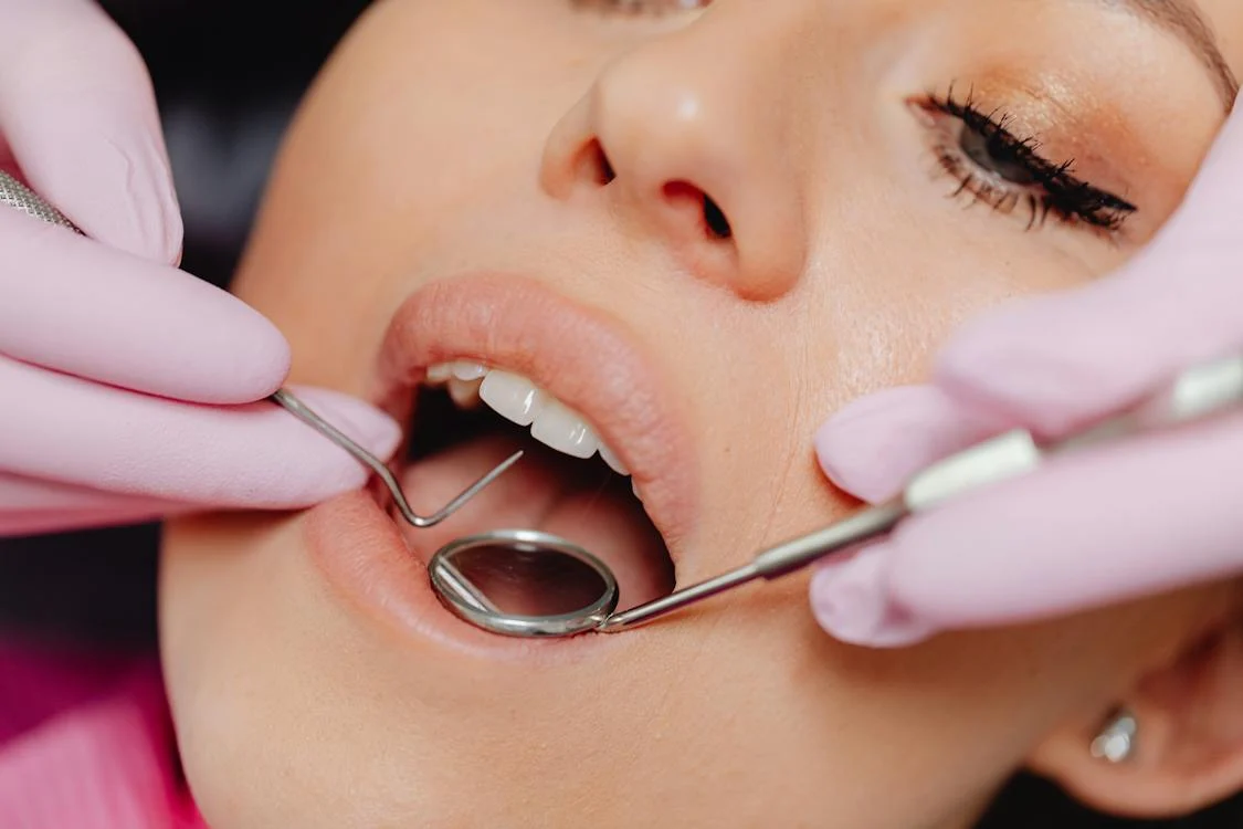 close-up shot of a woman's mouth with some dental tools in front