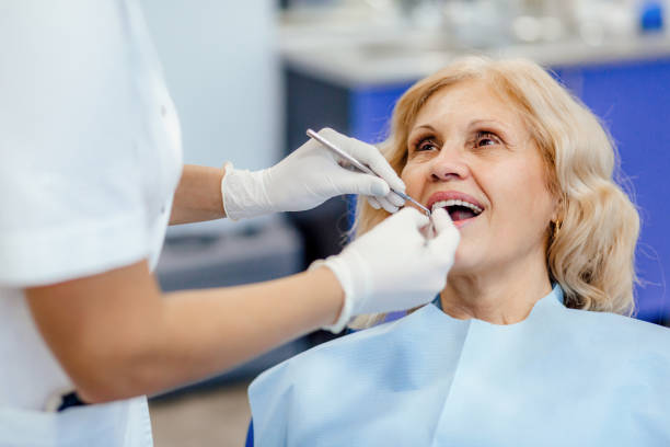 an elderly woman receiving her dental check-up