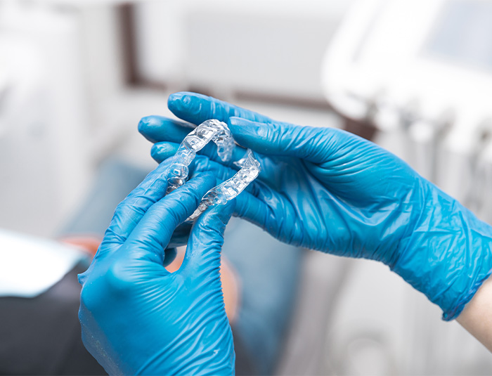 Dentist holding Invisalign