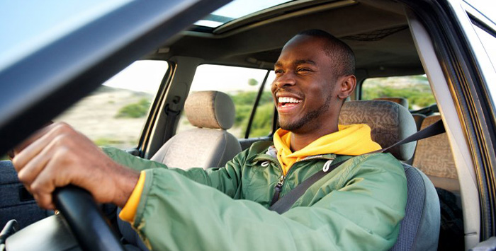 Man smiles as he drives