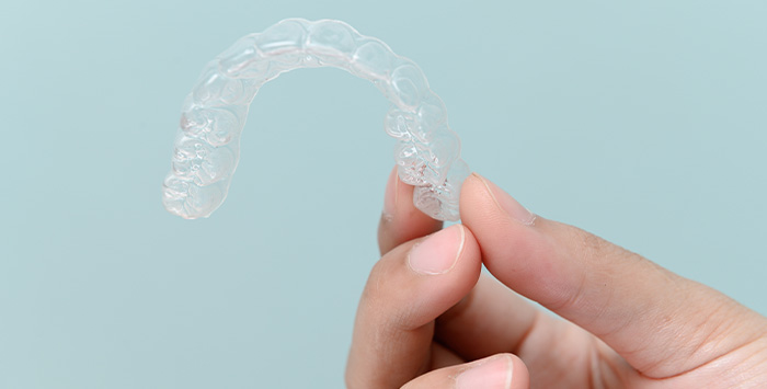 Patient holding clear aligner