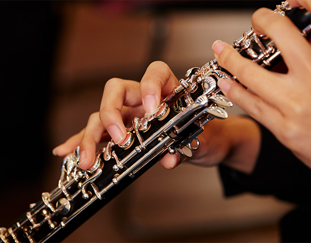 A person playing a clarinet in a dental office, surrounded by dental tools and equipment.